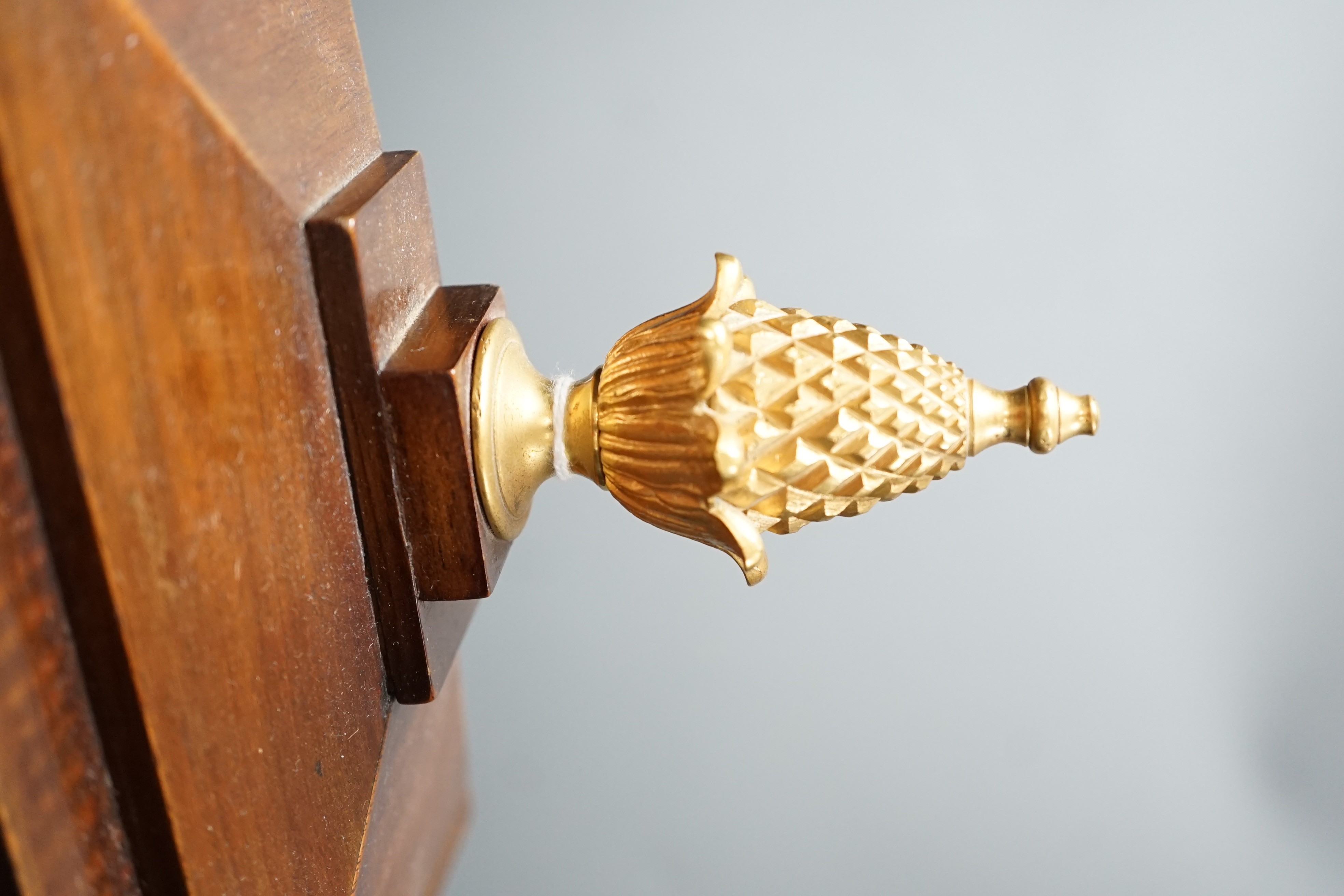 A Regency brass inlaid mahogany bracket clock, with pineapple finial, bears interior paper label Cuss & Co. 49cm high